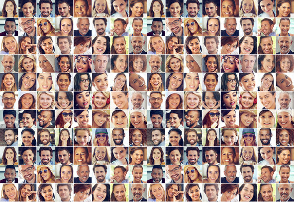 Composite image of a large group of diverse people smiling