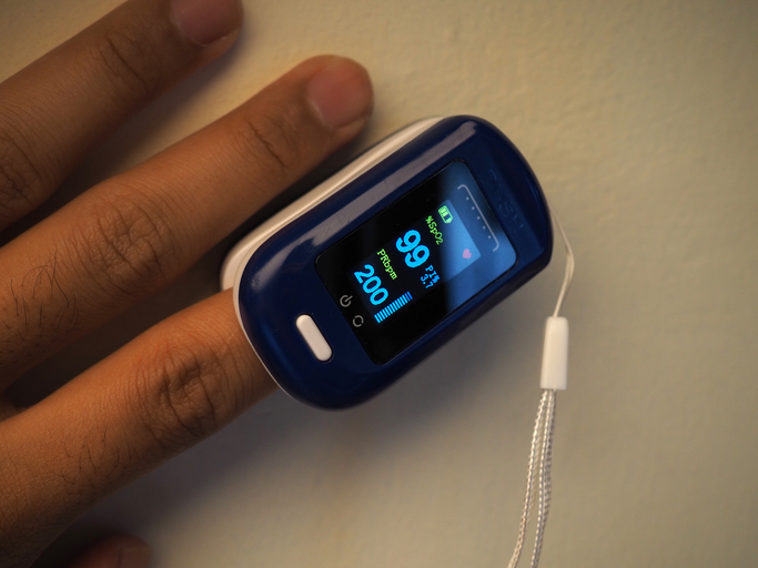 Photo of person wearing pulse oximeter