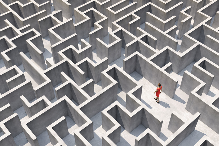 A woman walks through a maze