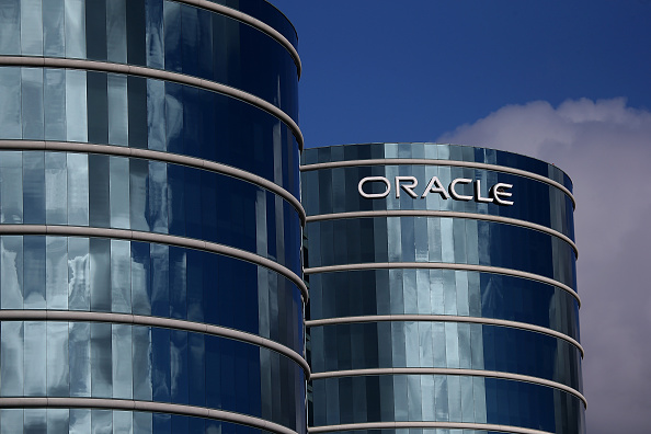Oracle's headquarters in Austin, with the "Oracle" logo pictured on the side of a curved building. 