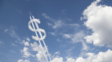 Jet trail creating dollar sign in blue sky with clouds startup capital