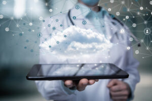 Doctor shows healthcare data cloud on tablet on blurred background.