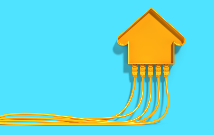 Yellow house icon connected with Ethernet cables on blue background, Smart home networking, internet, and IoT connectivity.