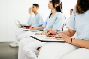 A group of nurses taking notes during a lecture at university.