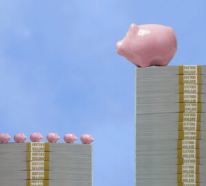 One very large ceramic piggy bank on tall pile of US paper currency looking down on 6 much small piggy banks