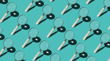 Magnifying Glass Focusing Sunlight Into a Point Repetition on Turquoise Colored Background High Angle View.
