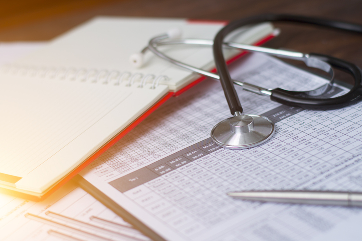 Health care costs. Stethoscope and calculator symbol