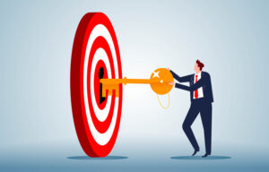 The key to achieving success or accomplishing a goal, the secret to success, the businessman holding the key and inserting it into the keyhole of the bullseye