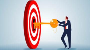 The key to achieving success or accomplishing a goal, the secret to success, the businessman holding the key and inserting it into the keyhole of the bullseye