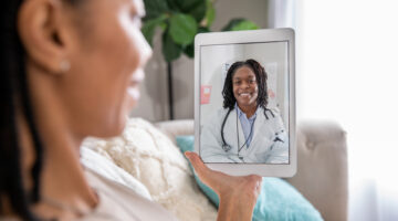 Mature woman discusses health issue with doctor during a telehealth appointment