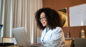Doctor using laptop to advise patients online