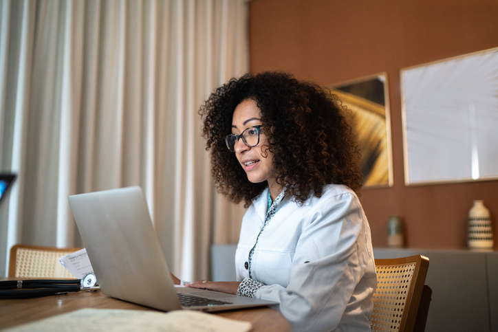 Doctor using laptop to advise patients online