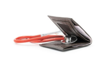 Financial health. Stethoscope in a wallet. Stethoscope check for money on empty wallet isolated on white background.