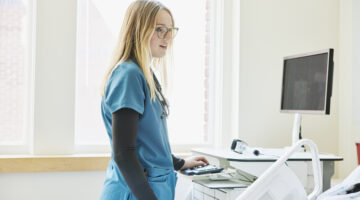 Medium shot of female nurse bedside in hospital emergency room