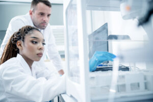 Multiracial scientists conducting medical tests and collecting results in a pharmaceutical laboratory.
