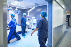 Motion medical staff in scrubs walking into surgery operating room