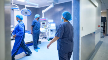 Motion medical staff in scrubs walking into surgery operating room