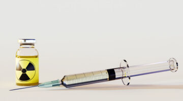 3d rendering of radioactive intravenous drug using a needle and syringe to inject a drug