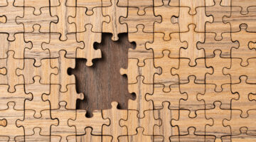 Wooden Jigsaw Puzzle About to Be Finished With a Blank Area Close-up Full Frame View.