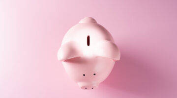 Spotlight Circle Light Focus on the Coin Slot of a Pink Colored Piggy Bank on Pink Background Directly Above View.