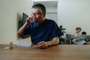 Senior man at home taking various medications