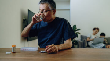 Senior man at home taking various medications