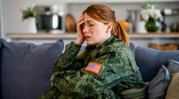 Young adult woman soldier getting professional help for stress related problems. She is suffering from post traumatic stress disorder