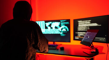 Hackers work secretly in secret rooms. Mysterious colored lights Breaking into personal security and various agencies in the world . Wanted Hacker using computer for hacking in the cyber data center .